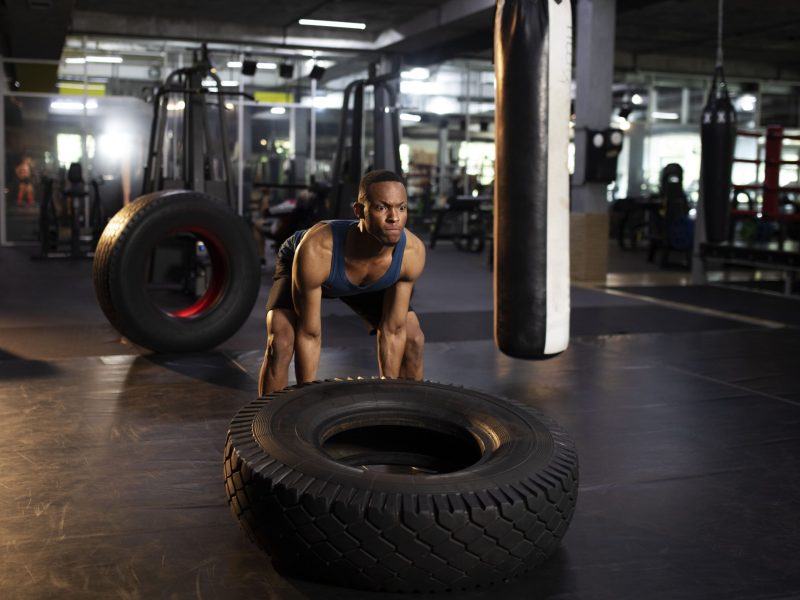 full-shot-man-training-with-giant-wheel-gym