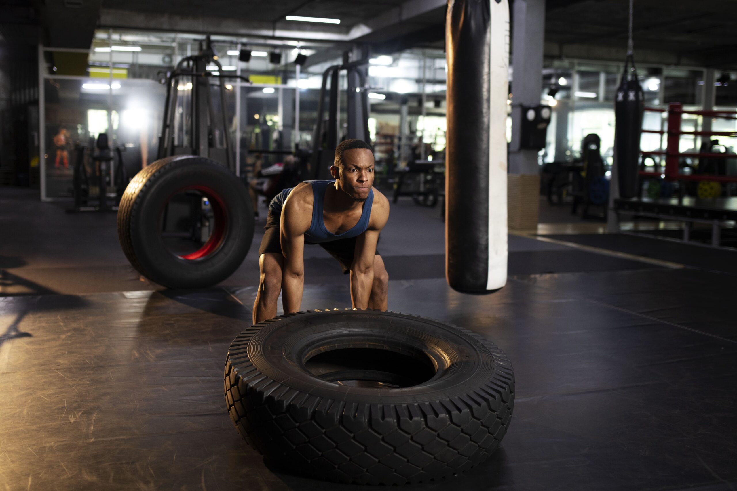 full-shot-man-training-with-giant-wheel-gym